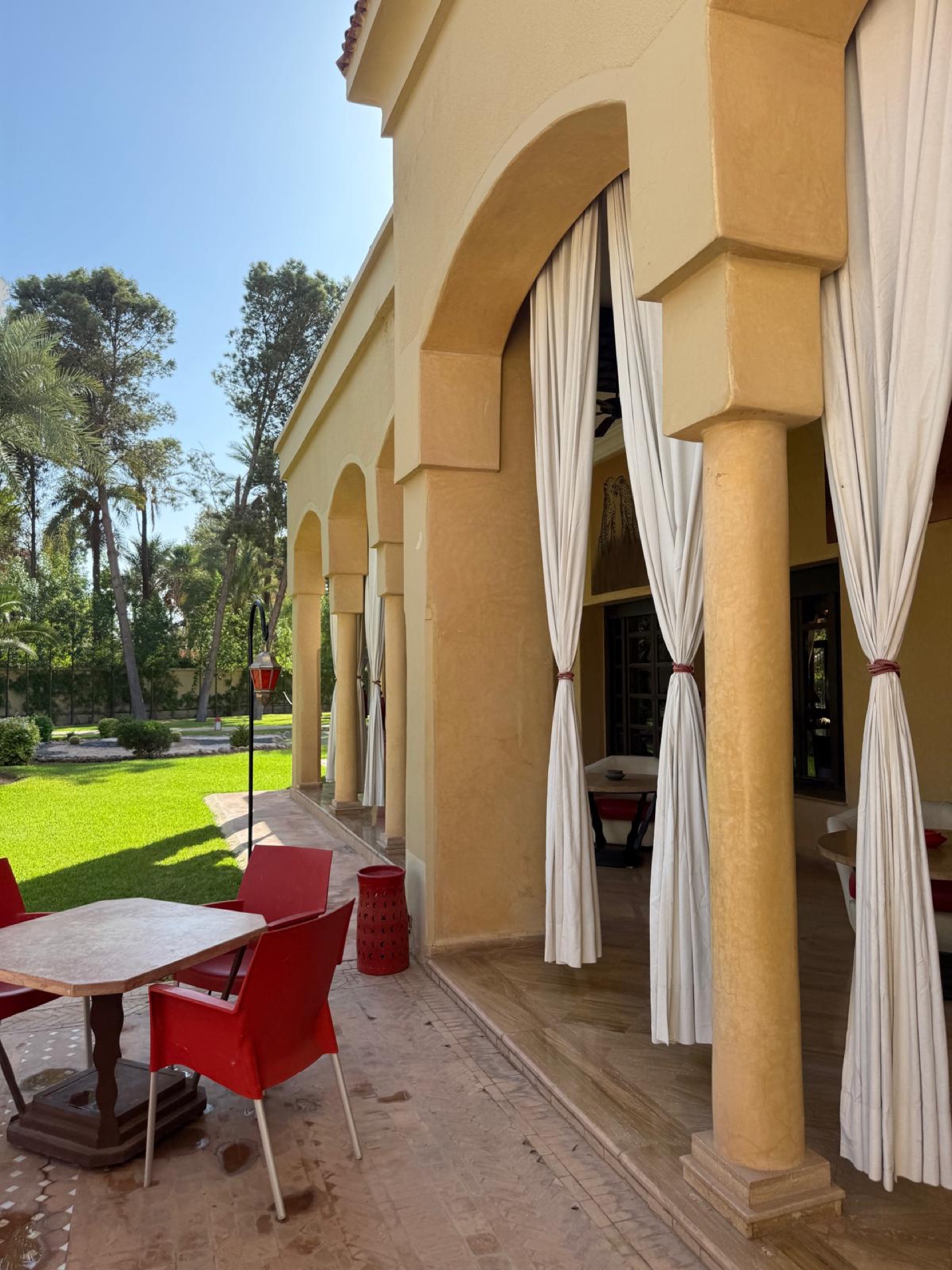 The arches of The Palais Monte Carlo opening onto the garden